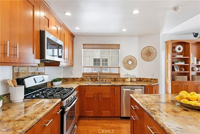1114 Vincent St Unit A, Redondo Beach, CA 90277 - kitchen featuring appliances with stainless steel finishes, light wood-type flooring, light stone countertops, brown cabinets, and recessed lighting