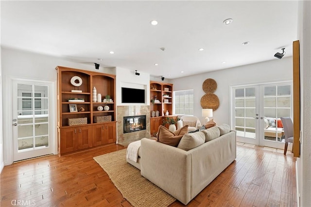 1114 Vincent St Unit A, Redondo Beach, CA 90277 - living room featuring french doors, a fireplace, light wood-type flooring, and recessed lighting