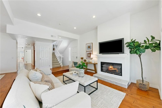 1114 Vincent St Unit A, Redondo Beach, CA 90277 - living room with stairway, light wood-type flooring, a glass covered fireplace, and recessed lighting