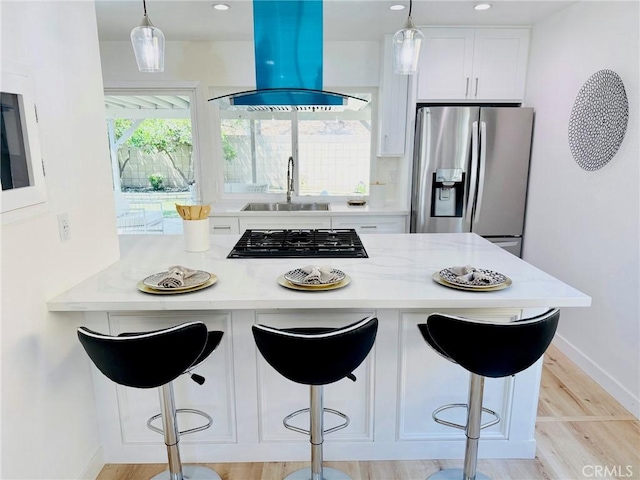 11143 Gonsalves Pl, Cerritos, CA 90703 - kitchen featuring stainless steel fridge, ventilation hood, black gas stovetop, white cabinets, and a breakfast bar area