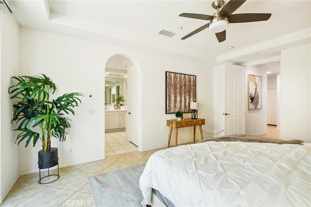 501 Newman Cir, Placentia, CA 92870 - bedroom featuring light tile patterned floors, a raised ceiling, arched walkways, and connected bathroom