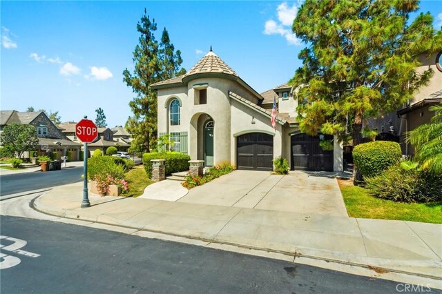 501 Newman Cir, Placentia, CA 92870 - french country style house with stucco siding, concrete driveway, and a garage