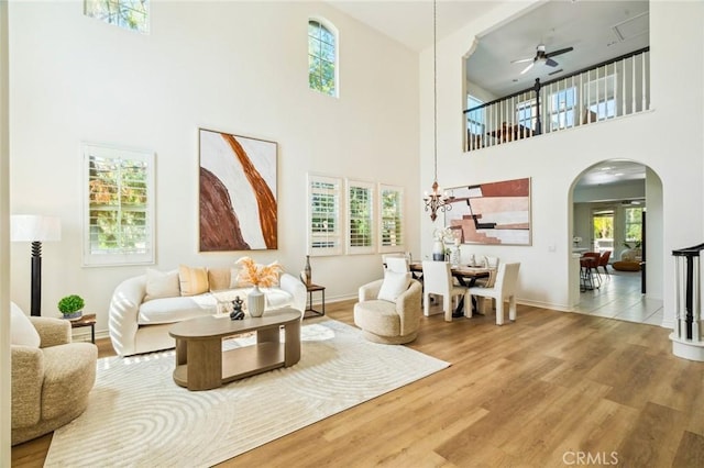 501 Newman Cir, Placentia, CA 92870 - living area with a towering ceiling, arched walkways, ceiling fan, healthy amount of natural light, and wood finished floors