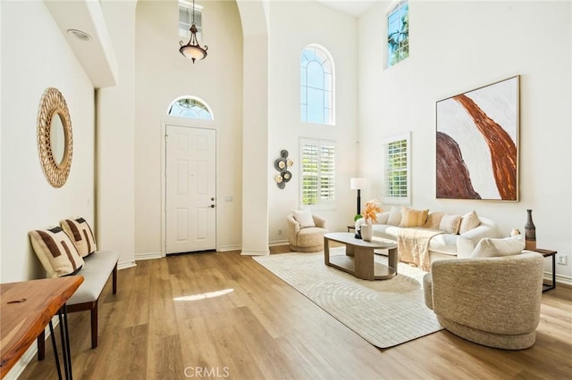 501 Newman Cir, Placentia, CA 92870 - entryway featuring wood finished floors, a towering ceiling, plenty of natural light, and arched walkways