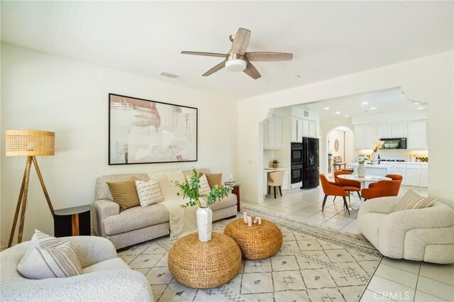 501 Newman Cir, Placentia, CA 92870 - living room featuring arched walkways, a ceiling fan, and light tile patterned floors