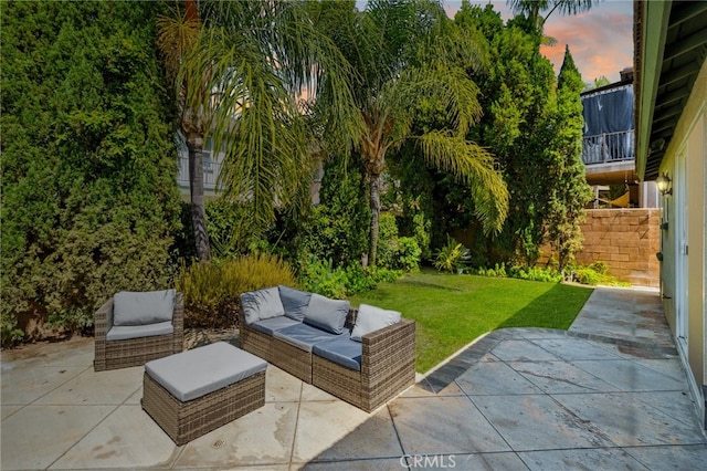 501 Newman Cir, Placentia, CA 92870 - patio terrace at dusk featuring a patio, a yard, and outdoor lounge area