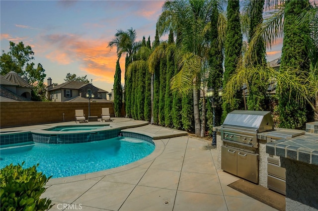 501 Newman Cir, Placentia, CA 92870 - pool at dusk with an outdoor kitchen, a patio area, and a pool with connected hot tub