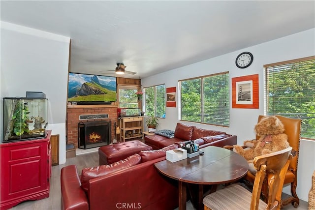 316 La Casita Dr, Twin Peaks, CA 92391 - living room featuring wood finished floors, ceiling fan, a brick fireplace, and plenty of natural light