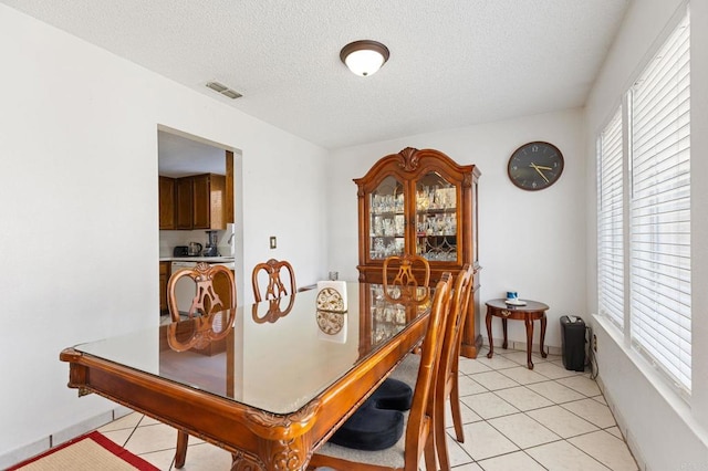 4068 De La Vina Way, Sacramento, CA 95823 - dining space featuring healthy amount of natural light, a textured ceiling, and light tile patterned floors