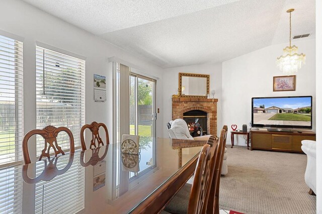4068 De La Vina Way, Sacramento, CA 95823 - dining area featuring light carpet, a chandelier, lofted ceiling, a fireplace, and a textured ceiling