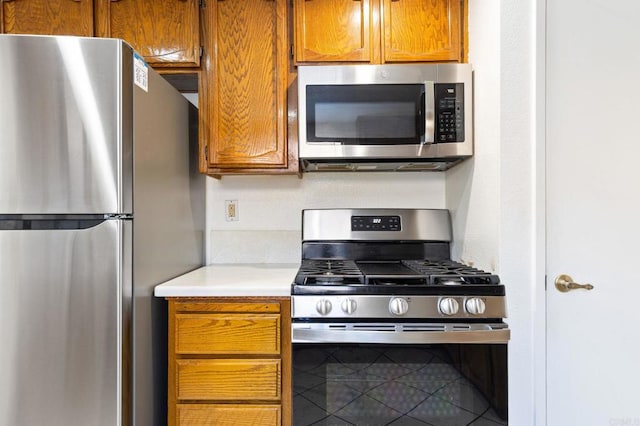 4068 De La Vina Way, Sacramento, CA 95823 - kitchen featuring appliances with stainless steel finishes, light countertops, brown cabinets, and tile patterned floors
