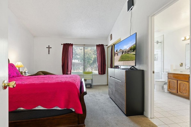 4068 De La Vina Way, Sacramento, CA 95823 - bedroom with a textured ceiling, connected bathroom, and light tile patterned floors