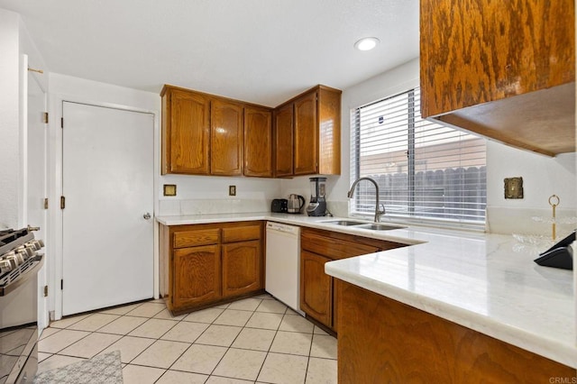 4068 De La Vina Way, Sacramento, CA 95823 - kitchen featuring white dishwasher, stainless steel gas range, brown cabinetry, and light tile patterned floors