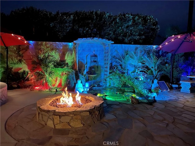 9830 Mesquite Ave, Desert Hot Springs, CA 92240 - patio at twilight with a fire pit and a patio area