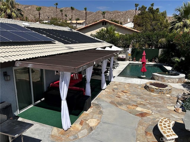 9830 Mesquite Ave, Desert Hot Springs, CA 92240 - view of swimming pool with an outdoor fire pit, a mountain view, a patio, and a fenced backyard