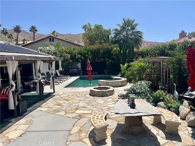 9830 Mesquite Ave, Desert Hot Springs, CA 92240 - fenced backyard with a fire pit, a patio area, a gazebo, and a mountain view