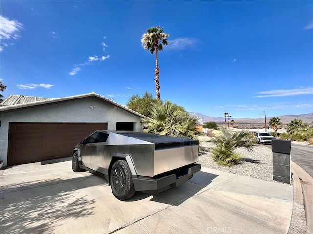 9830 Mesquite Ave, Desert Hot Springs, CA 92240 - view of home's exterior with a mountain view, stucco siding, and driveway