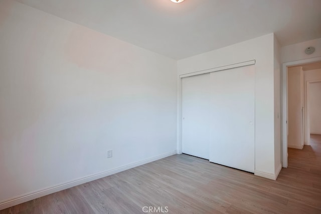 9063 Rosecrest Ln, Fontana, CA 92335 - unfurnished bedroom with wood finished floors and a closet