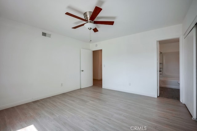 9063 Rosecrest Ln, Fontana, CA 92335 - unfurnished bedroom featuring light wood-type flooring, ensuite bath, and ceiling fan