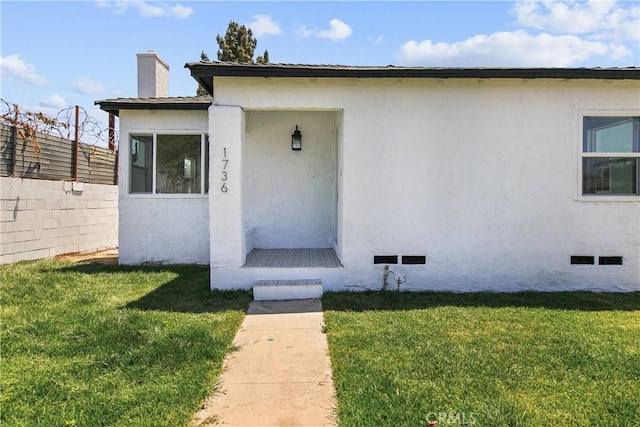 1736 N Mcdivitt Ave, Compton, CA 90221 - view of front of house with stucco siding, a chimney, and crawl space