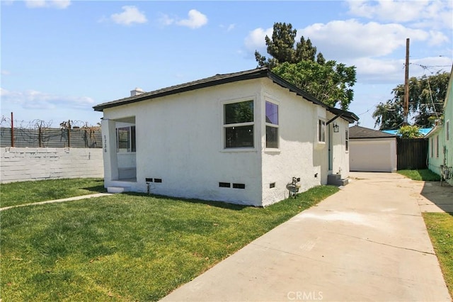 1736 N Mcdivitt Ave, Compton, CA 90221 - view of side of property featuring crawl space, a detached garage, stucco siding, driveway, and an outdoor structure