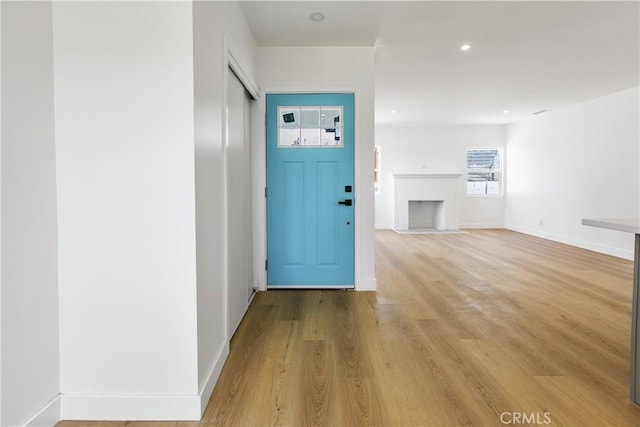1736 N Mcdivitt Ave, Compton, CA 90221 - foyer featuring light wood-style floors, a fireplace with flush hearth, and recessed lighting
