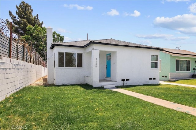 1736 N Mcdivitt Ave, Compton, CA 90221 - view of front of house featuring stucco siding and roof mounted solar panels