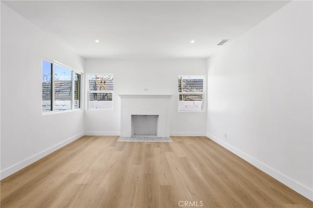 1736 N Mcdivitt Ave, Compton, CA 90221 - unfurnished living room featuring light wood-style floors, a brick fireplace, and recessed lighting