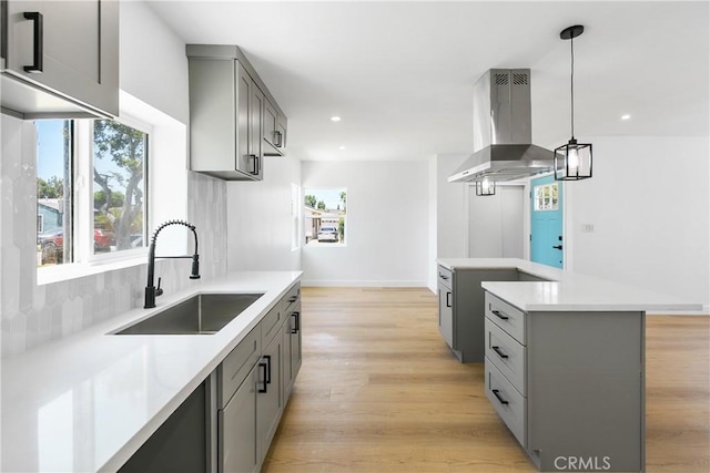 1736 N Mcdivitt Ave, Compton, CA 90221 - kitchen with ventilation hood, gray cabinets, light countertops, light wood-style floors, and recessed lighting