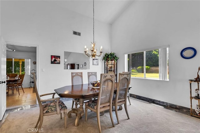 17262 Chase St, Northridge, CA 91325 - dining room with healthy amount of natural light, a chandelier, high vaulted ceiling, and light carpet