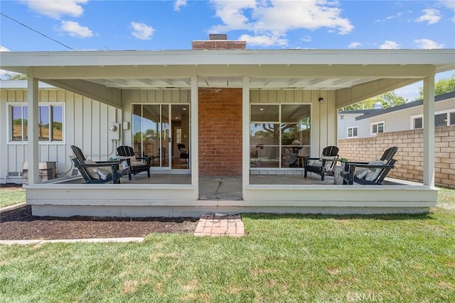 2781 Vuelta Grande Ave, Long Beach, CA 90815 - back of house featuring board and batten siding, a chimney, and brick siding