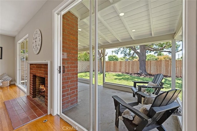 2781 Vuelta Grande Ave, Long Beach, CA 90815 - sunroom with wood finished floors and an outdoor brick fireplace