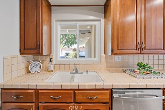 2781 Vuelta Grande Ave, Long Beach, CA 90815 - kitchen with stainless steel dishwasher, tasteful backsplash, light countertops, and crown molding