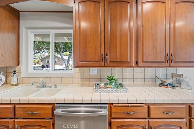 2781 Vuelta Grande Ave, Long Beach, CA 90815 - kitchen featuring stainless steel dishwasher, backsplash, light countertops, and brown cabinets