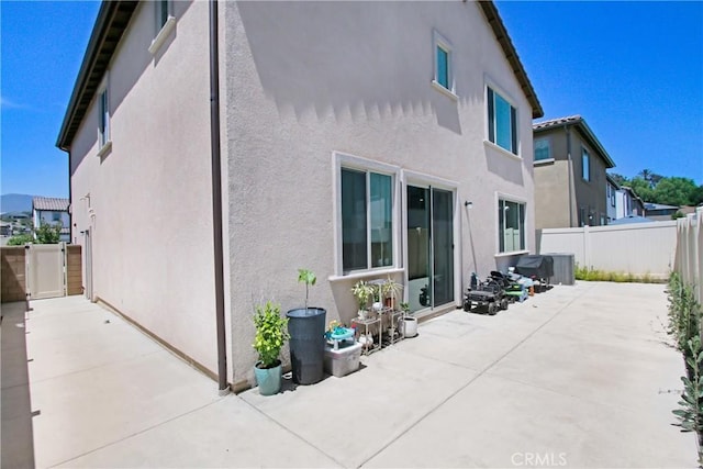 2278 Yuzu St, Corona, CA 92883 - back of house with stucco siding, a patio area, and a fenced backyard