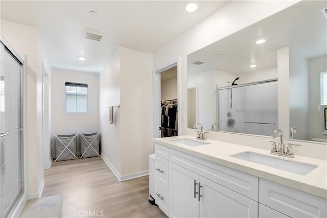 2278 Yuzu St, Corona, CA 92883 - full bath featuring double vanity, a stall shower, a walk in closet, wood finished floors, and recessed lighting