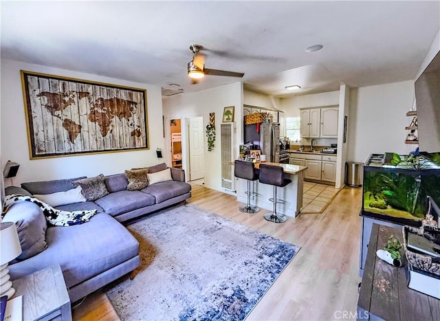 4216 Dalton Ave, Los Angeles, CA 90062 - living room with light wood-style floors and a ceiling fan