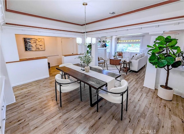 4216 Dalton Ave, Los Angeles, CA 90062 - dining room featuring light wood finished floors and ornamental molding