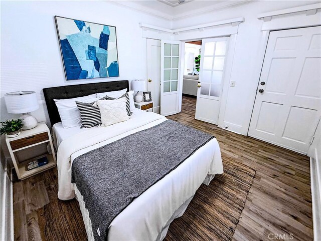 4216 Dalton Ave, Los Angeles, CA 90062 - bedroom featuring wood finished floors, french doors, a closet, and ornamental molding