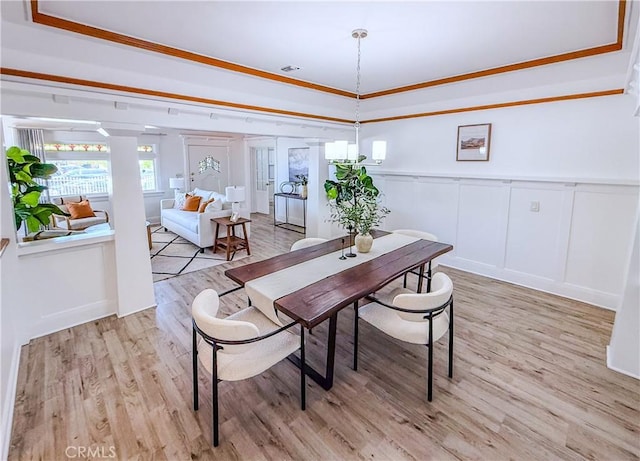4216 Dalton Ave, Los Angeles, CA 90062 - dining area with a decorative wall, light wood-style flooring, a wainscoted wall, and a raised ceiling