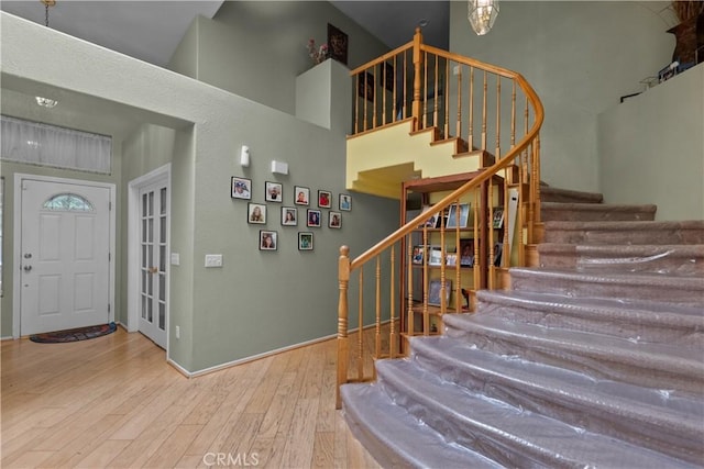 42012 57th St W, Lancaster, CA 93536 - entryway with stairs, a towering ceiling, and wood finished floors