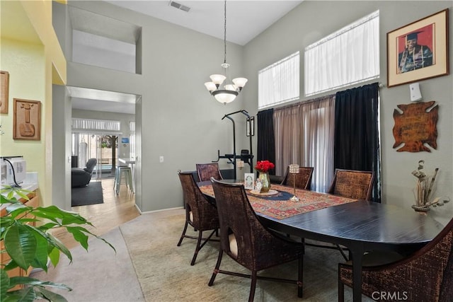 42012 57th St W, Lancaster, CA 93536 - dining room featuring a towering ceiling, a chandelier, and light carpet