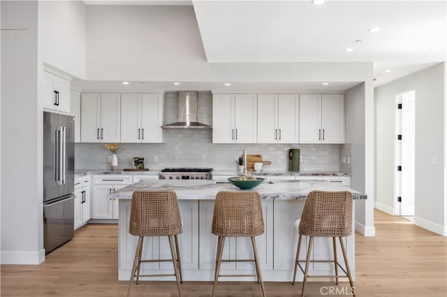 2405 Mathews Ave Unit C, Redondo Beach, CA 90278 - kitchen featuring high quality fridge, wall chimney exhaust hood, decorative backsplash, a breakfast bar, and recessed lighting