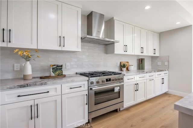 2405 Mathews Ave Unit C, Redondo Beach, CA 90278 - kitchen featuring wall chimney exhaust hood, stainless steel range, white cabinets, light wood finished floors, and recessed lighting