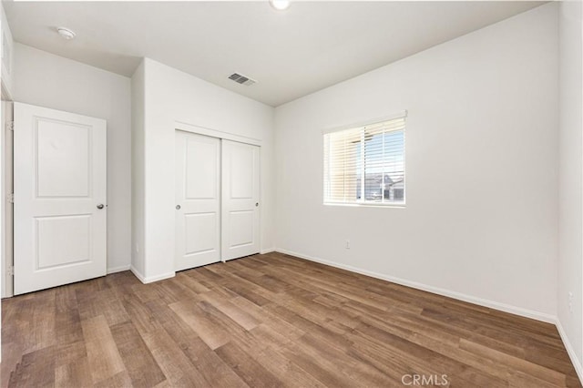7305 Scrivia Ct, Bakersfield, CA 93311 - unfurnished bedroom with wood finished floors and a closet
