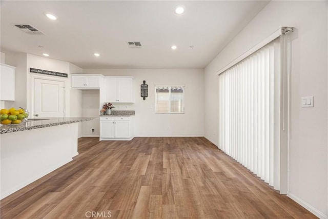 7305 Scrivia Ct, Bakersfield, CA 93311 - unfurnished living room featuring light wood-style flooring and recessed lighting