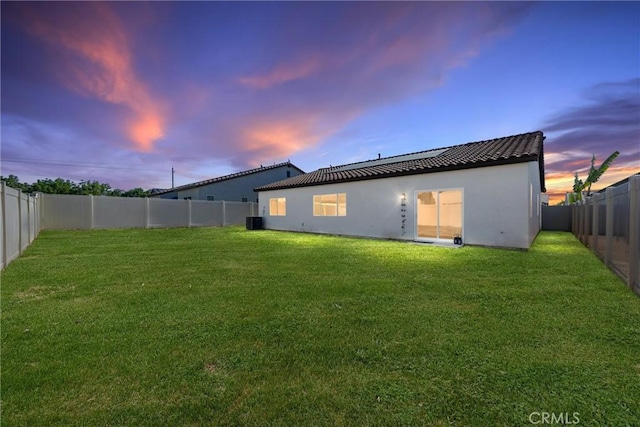 7305 Scrivia Ct, Bakersfield, CA 93311 - back of property at dusk with a fenced backyard and stucco siding