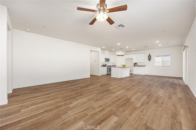 7305 Scrivia Ct, Bakersfield, CA 93311 - unfurnished living room featuring light wood-style flooring, recessed lighting, and a ceiling fan