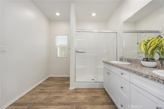 7305 Scrivia Ct, Bakersfield, CA 93311 - full bathroom with a stall shower, wood finished floors, double vanity, and recessed lighting