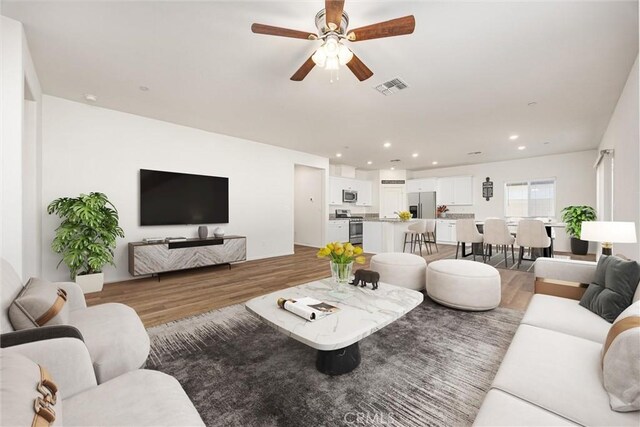 7305 Scrivia Ct, Bakersfield, CA 93311 - living area with light wood-style flooring, ceiling fan, and recessed lighting